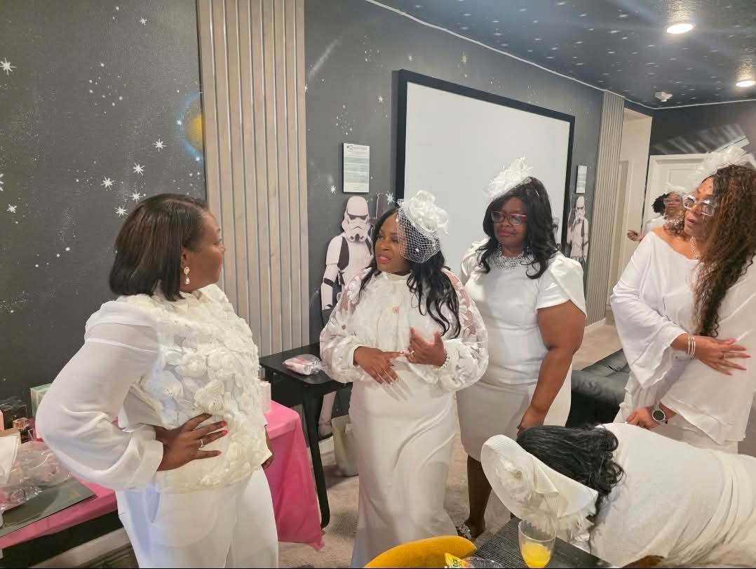 Members networking in white attire at a past event